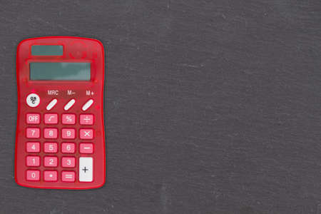 Blank old grunge black chalkboard with a calculator background with copy space for your school...
