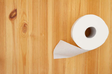 Toilet paper roll on a wood table with copy spaceの写真素材