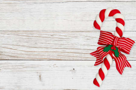 Christmas background with retro Christmas candy cane on distressed whitewash with copy space for...