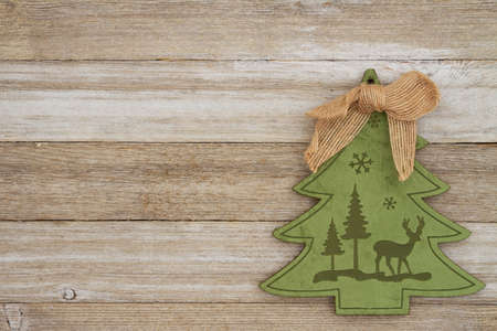Felt Christmas tree with grunge wood background with copy space for your holiday messageの写真素材
