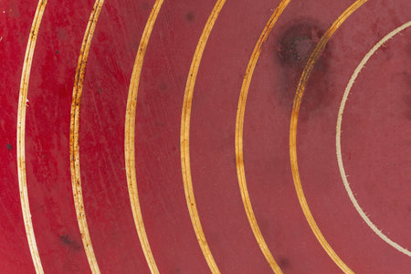 Red scratched metal grunge textured material background with copy space for message or use as a textureの写真素材