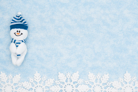 Happy snowman with blue snowflake background for your holiday or winter messageの写真素材