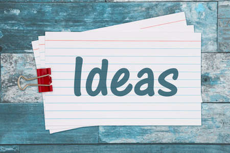 Ideas message on retro white paper index cards with paper clip on weathered woodの写真素材