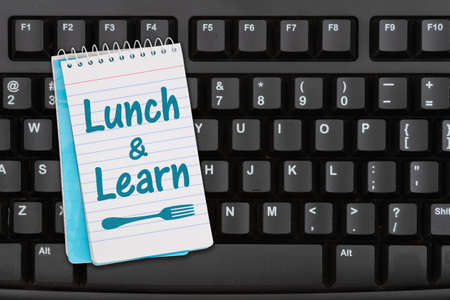 Lunch and Learn message on a notepad on a black keyboardの写真素材