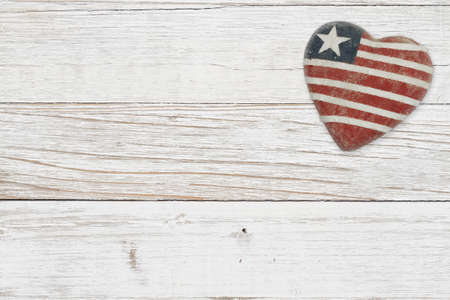Old heart American flag on weathered whitewash wood with copy space for your United States message