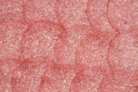 Genoa sliced salami background with top viewの写真素材