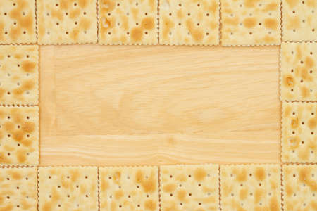 Saltine crackers border with wood background with copy space for your snack messageの写真素材