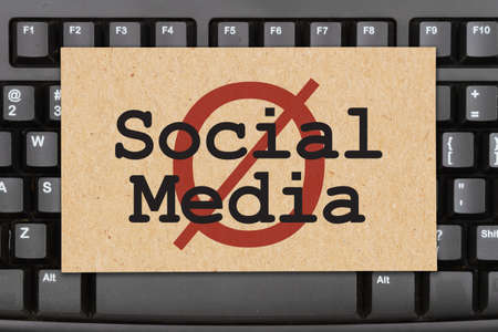 No social media message with ban symbol on a black keyboardの写真素材