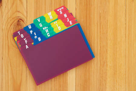 Blank alphabet plastic index cards on wood desk with copy space for your message