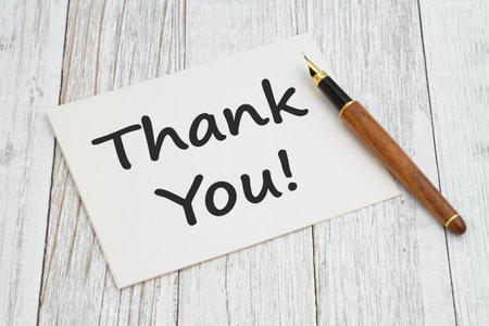 Thank You greeting card with calligraphy pen on old whitewashed wood deskの写真素材