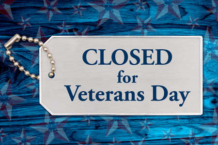 Closed for Veterans day sign on silver tag with red, white, and blue US flag starsの写真素材