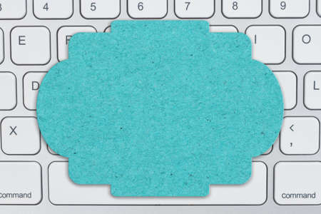 Blank teal sign on gray keyboard for your online sales message