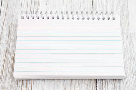 Blank lined notepad on weathered wood with copy space for your message