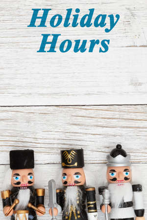 Holiday Hours sign with three nutcrackers Christmas border with weathered wood with space for you to...