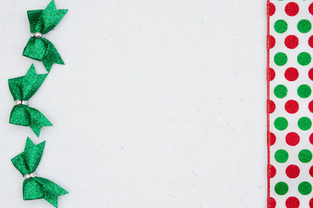 Christmas background with bows and red and green polka dots white sparkles felt with copy space for your Christmas messageの写真素材