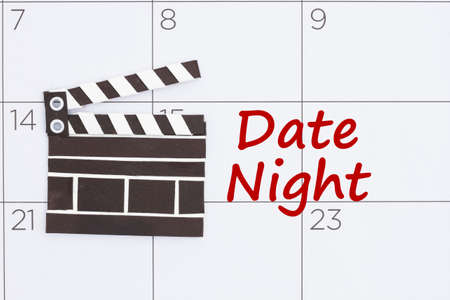 Date Night entry message on a calendar with a movie clapperの写真素材