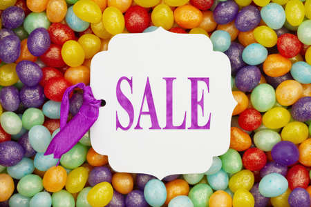 Sale message gift tag over colorful jellybean candy for your Easter or candy messageの写真素材