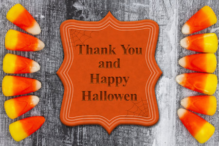 Thank you and Happy Halloween sign with candy corn and weathered wood