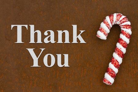 Thank you holiday message with candy cane on weathered rusting metalの写真素材