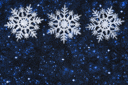 White snowflakes with stars holiday background for your winter or seasonal messageの写真素材