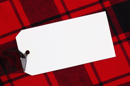 Blank gift card on red buffalo plaid for your holiday messageの写真素材