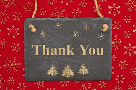 Thank you message on a chalkboard sign with snowflakes for your winter or seasonal messageの写真素材