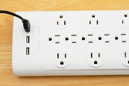Black surge and ground protector with USB protection on wood desk