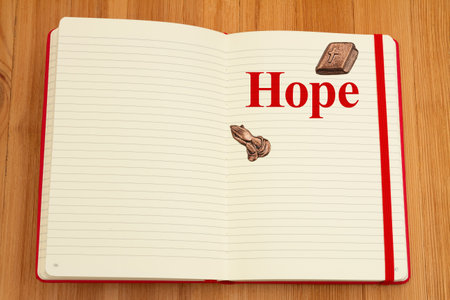 Hope message with bible and praying hands on lined journal on wood desk for your daily writing...