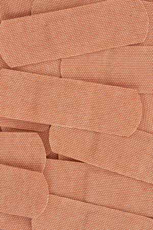 Lots of fabric adhesive aids background with for your medical or injury messageの写真素材