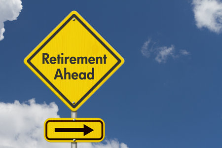 Retirement Ahead message on yellow warning road sign with skyの写真素材