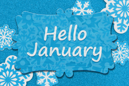 Hello January message on wood sign on snowflakes on blue glitter materialの写真素材