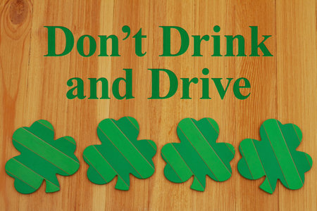 Donâ€™t Drink and drive message with green shamrocks on wood for saint patricks day