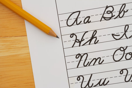 Cursive writing on vintage ruled line notebook paper with a pencilの写真素材