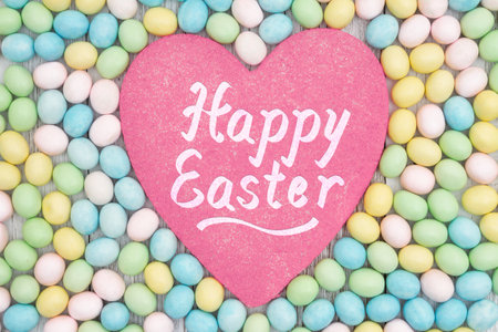 Happy Easter greeting card with pastel Easter eggs and heart