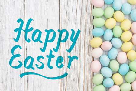 Happy Easter greeting card with Easter eggs on weathered wood