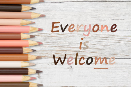 Everyone is Welcome message with multiculture skin tone color pencils crayons on lined paperの写真素材