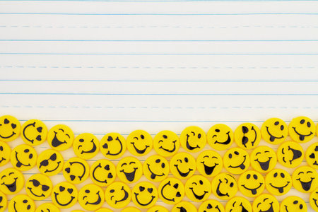Yellow happy buttons border on lined paper for your great messageの写真素材