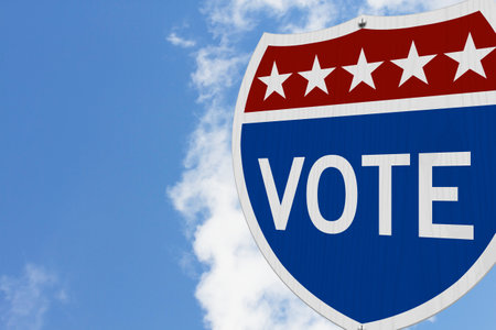 Vote message on USA highway road sign with skyの写真素材
