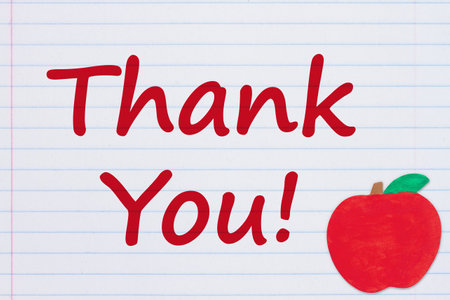 Thank You message with an apple on vintage ruled line notebook paper for you education or school messageの写真素材