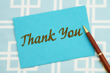 Thank you greeting blue card and pen with squares materialの写真素材