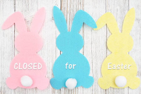 Closed for Eater sign with a bunny pink, blue and yellow on weathered wood