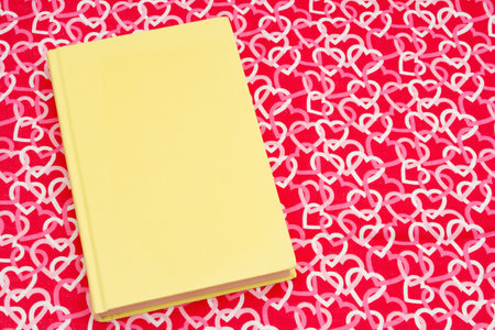 The love of reading with retro old yellow book with red and white heartsの写真素材