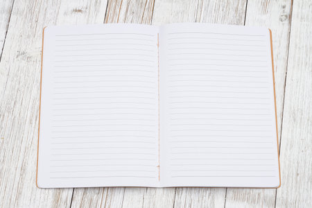 Ruled line journal paper page notepad on weathered desk for writing or journalingの写真素材