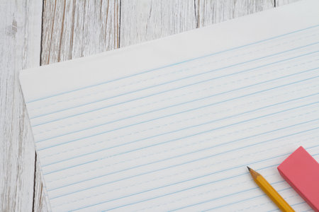 Ruled lined paper with pencil for school on weathered wood desk, table, wood,
