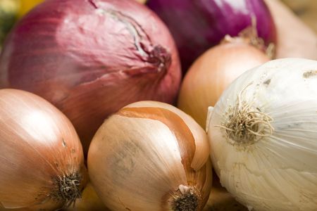 Onions and other  vegetables on a table during cookingの写真素材
