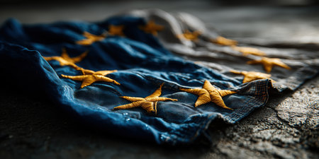 European flag lying on the ground, EU flag on asphalt, immigration, politics, for news, illegal immigration. High qualityの素材