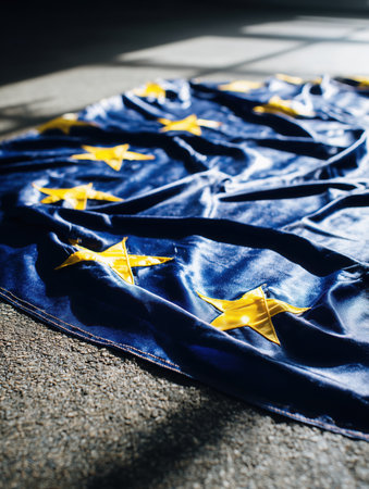 European flag lying on the ground, EU flag on asphalt, immigration, politics, for news, illegal immigration. High qualityの素材