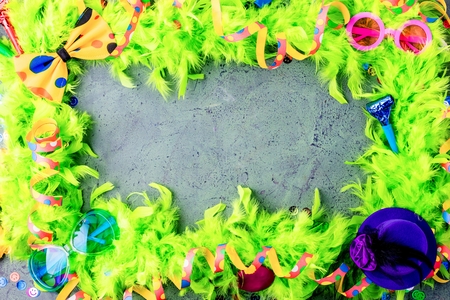 Colorful birthday or carnival frame with party items on stone backgroundの写真素材