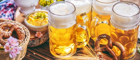 Oktoberfest beer, pretzels and various Bavarian specialties on wooden backgroundの写真素材
