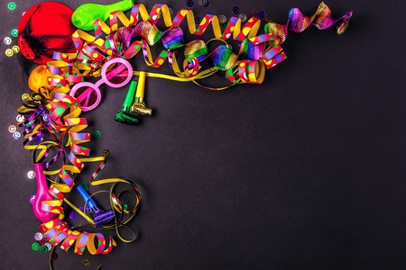 Colorful birthday or carnival frame with party items on stone backgroundの写真素材
